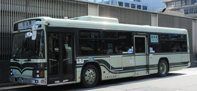 A green and white Kyoto City Bus at the Kyoto Station bus terminal