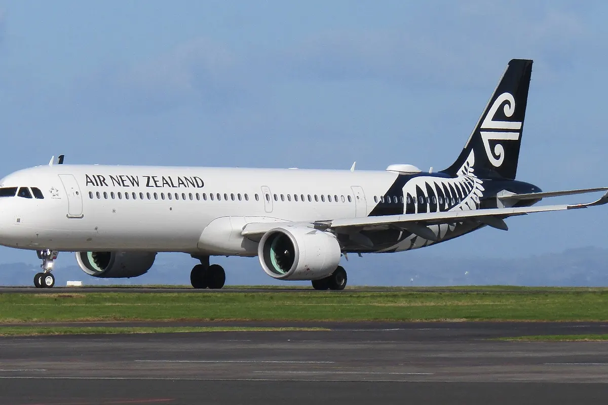 Air New Zealand Airbus A321 aircraft on an airport runway, with the airline's silver fern logo on the tail