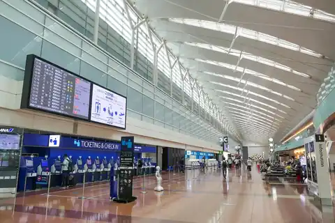 Check-in counters and a flight information board in the departure lobby of Haneda Airport Terminal 2