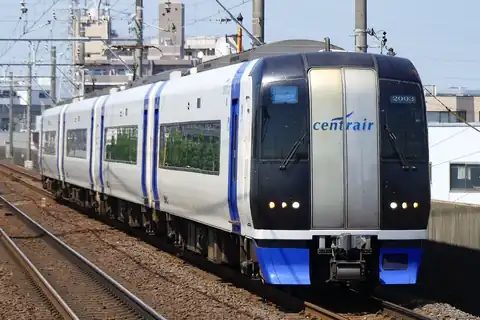 A white and blue Meitetsu mu-SKY limited express train (2000 series) curving along the tracks
