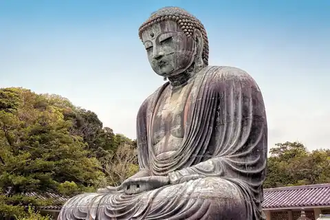 The Great Buddha bronze statue at Kotoku-in temple in Kamakura, surrounded by trees