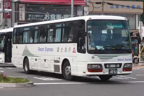 A white Fujikyu Resort Express highway bus on a street in Kawaguchiko