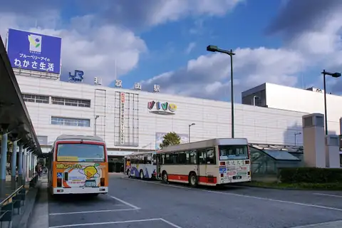 Exterior of JR Wakayama Station with buses in front of the building
