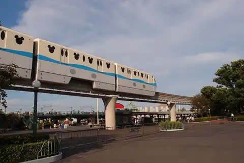 Disney Resort Line monorail on an elevated track at Tokyo Disney Resort, with Mickey Mouse head shapes on its cars