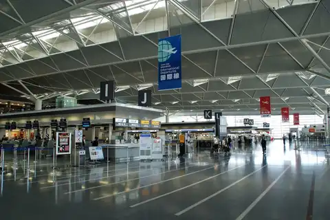 Check-in hall of Chubu Centrair Airport with international counters and a triangular-truss ceiling