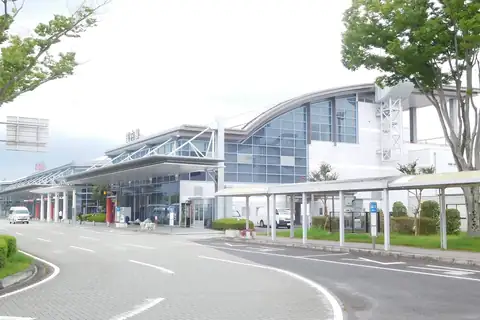 Fukushima Airport terminal building exterior with a curved roof and glass facade