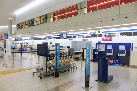 ANA check-in counter with luggage carts inside Hiroshima Airport terminal building