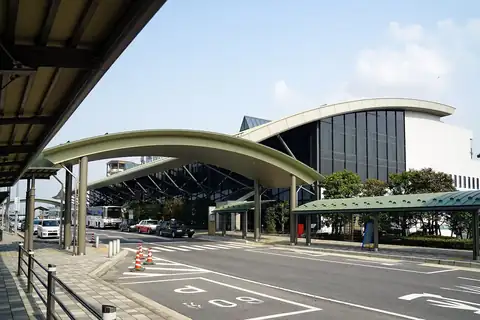 Exterior of Izumo Airport terminal building with curved roof and buses outside