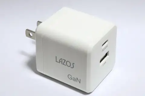 A white USB wall charger with two USB ports, labeled Lazos GaN