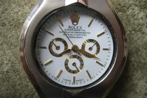 A counterfeit wristwatch made to look like a Rolex, with the letter O replaced by Q on the dial