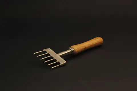 A six-pronged ice pick with a wooden handle