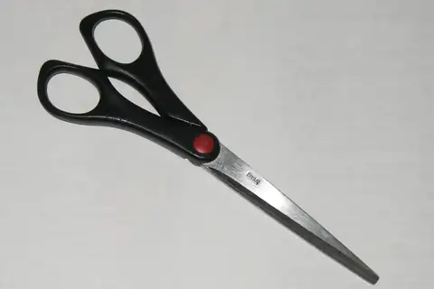 A pair of open scissors with black handles and a red pivot