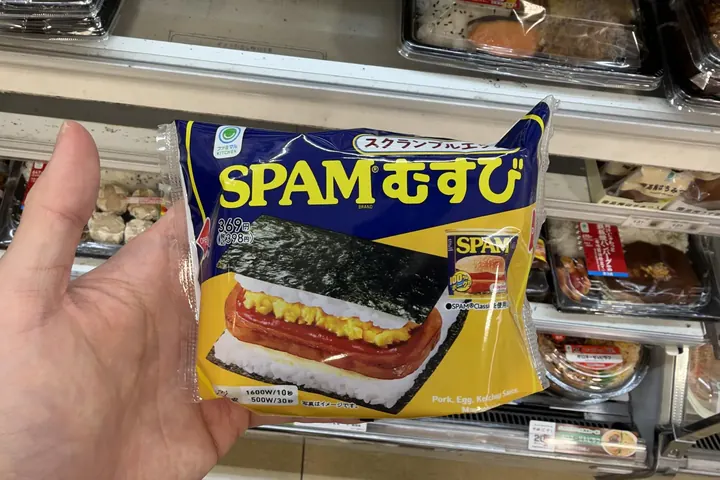 A SPAM musubi with scrambled egg held in a FamilyMart in Tokyo on 20 October 2026; the wrapper says Pork, Egg in English