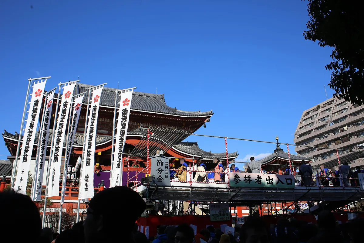 Osu Kannon temple hall with white banners and a stage for the Setsubun ceremony