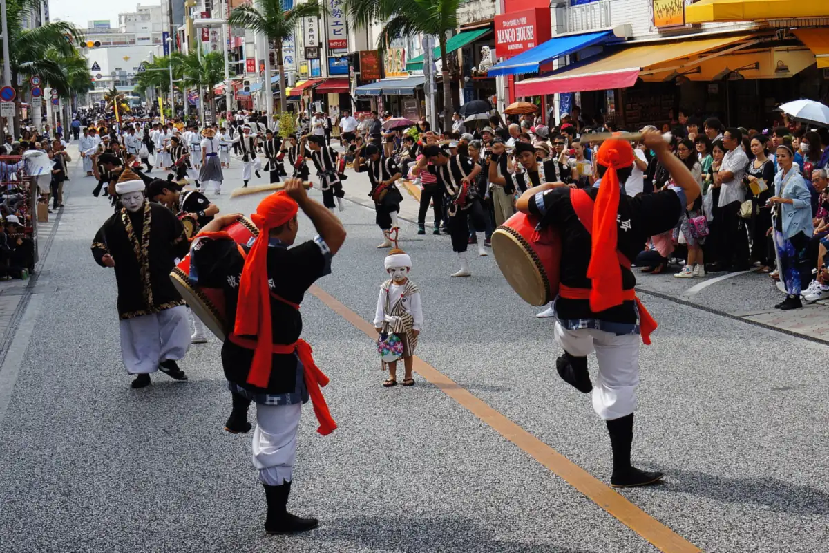 Eisa drummers in red headscarves dancing down Kokusai-dori in Naha during the Shuri Castle Festival parade