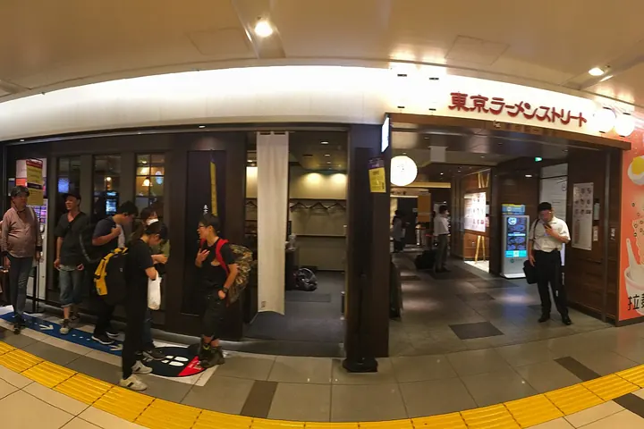 Entrance to Tokyo Ramen Street in Tokyo Station, with customers queuing outside a shop