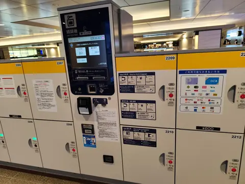 Coin lockers with a touch-screen payment machine at Osaka Station.