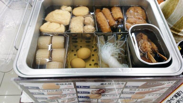 A convenience store oden pot with sectioned trays of daikon, eggs and other simmered ingredients