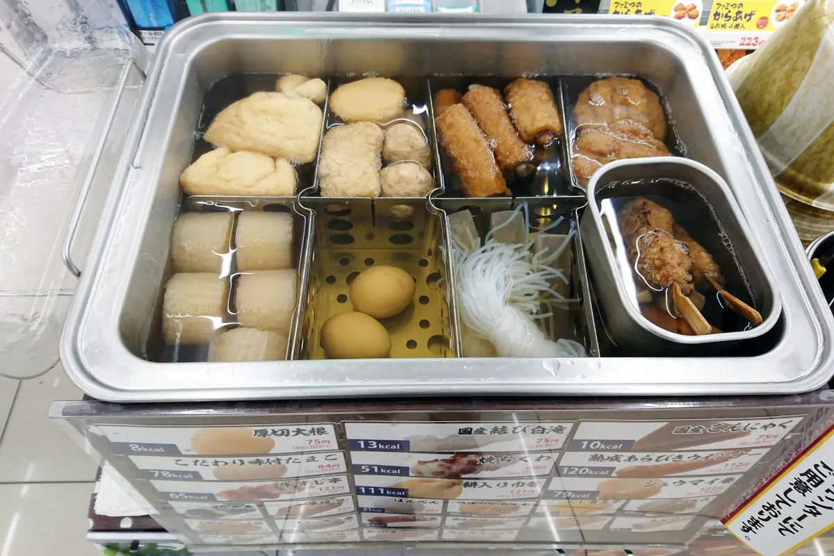A convenience store oden pot with sectioned trays of daikon, eggs, and other simmered ingredients