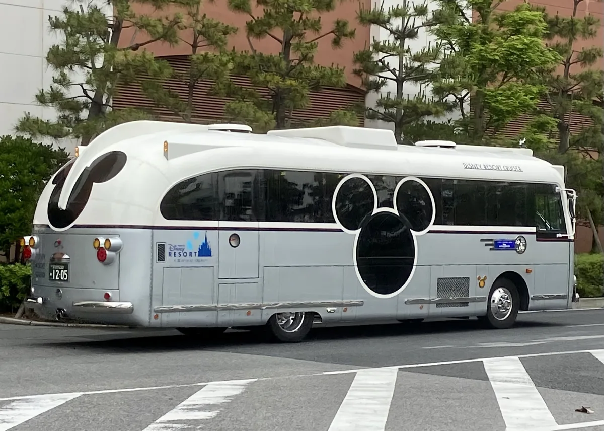 Disney Resort Cruiser bus with Mickey-shaped windows on the road