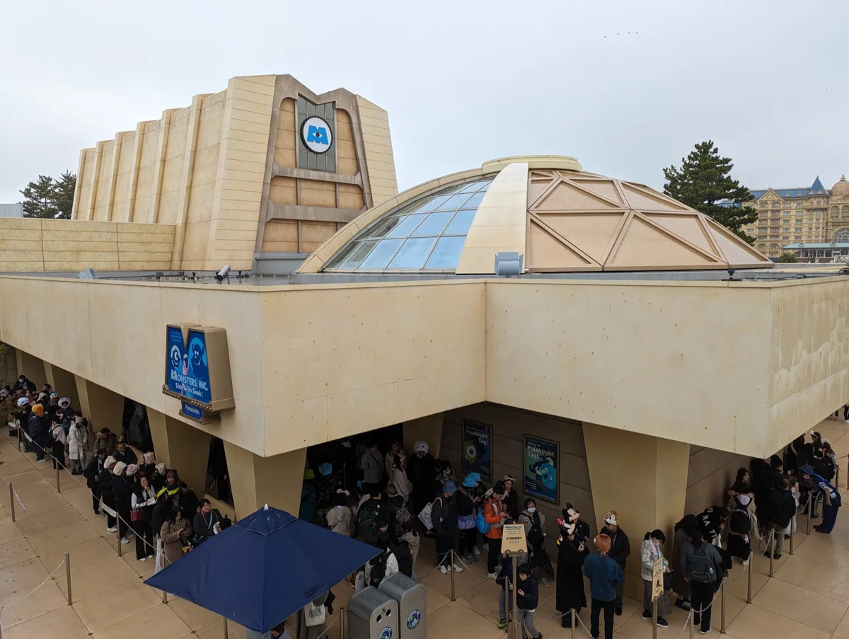 Monsters, Inc. Ride & Go Seek! building with a queue along its wall