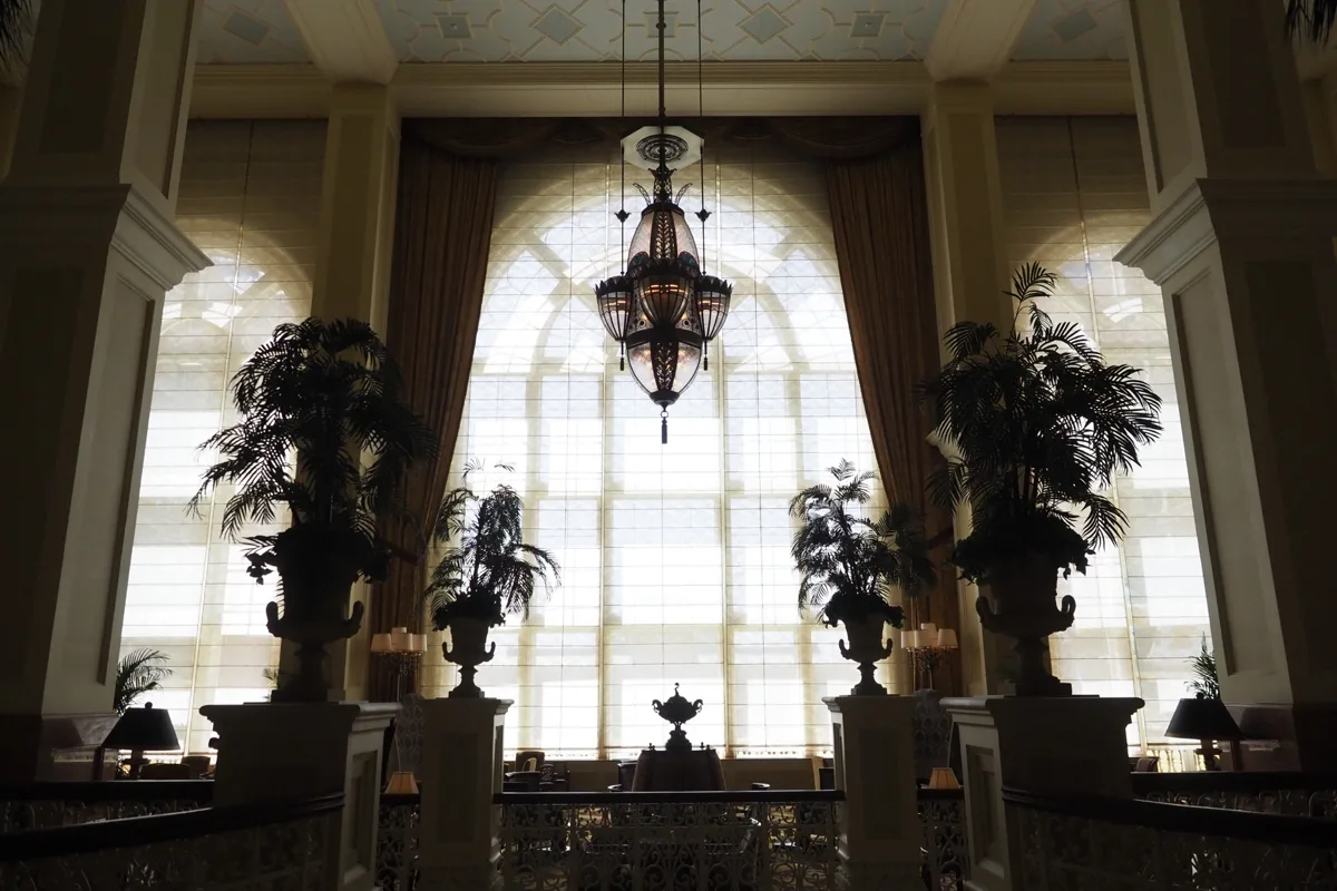 Tall arched windows and chandelier in the lobby of the Tokyo Disneyland Hotel