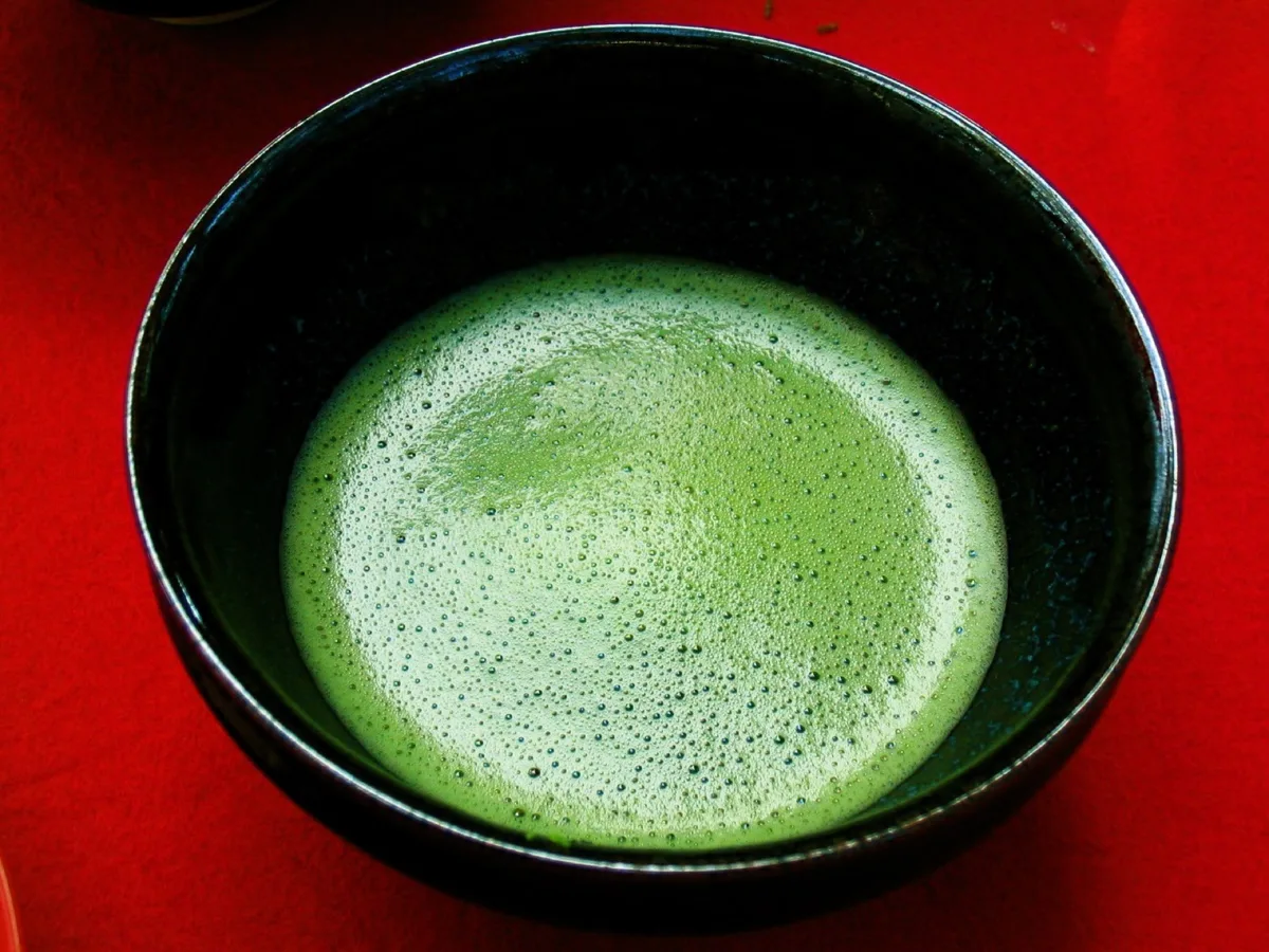 A bowl of whisked matcha with fine green foam