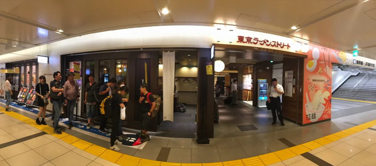 The entrance of Tokyo Ramen Street in an underground passage at Tokyo Station, with people waiting outside