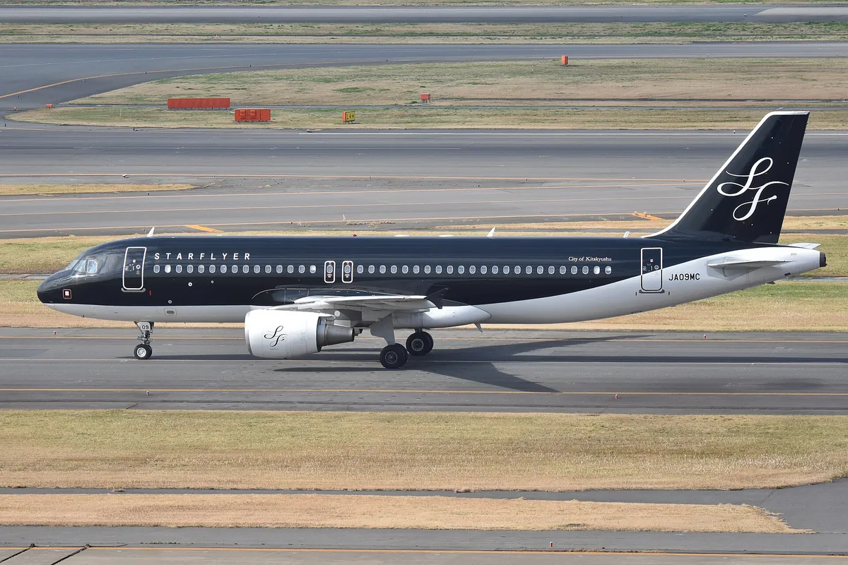 StarFlyer Airbus A320 in black livery taxiing on the runway