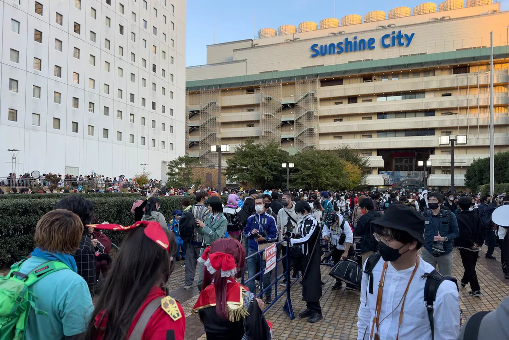 A large crowd of cosplayers and attendees gathered in front of the Sunshine City building in Ikebukuro, Tokyo