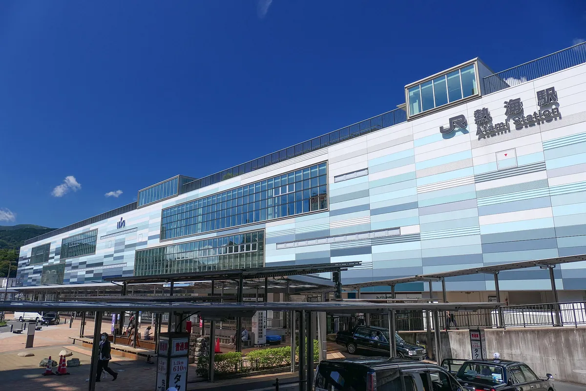 The modern glass-paneled building of JR Atami Station in Shizuoka Prefecture