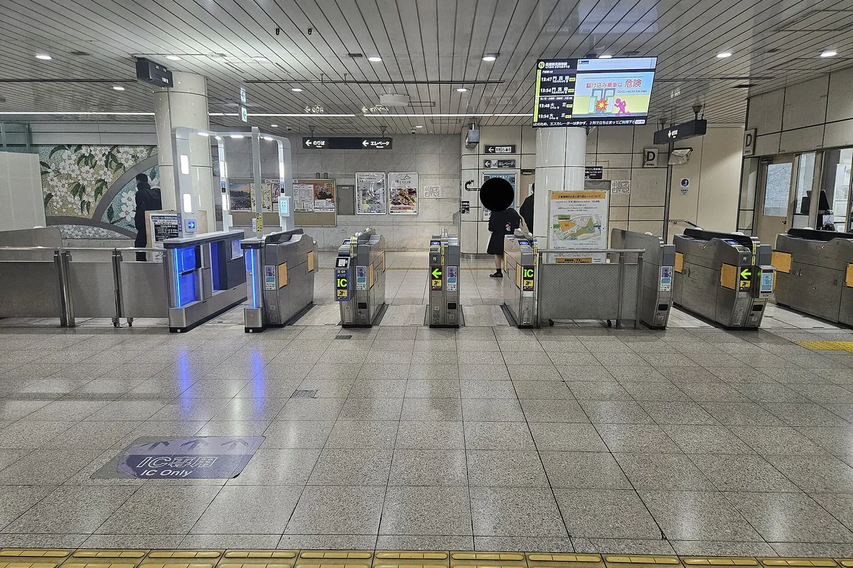 Rows of ticket gates with IC card readers at an Osaka Metro station