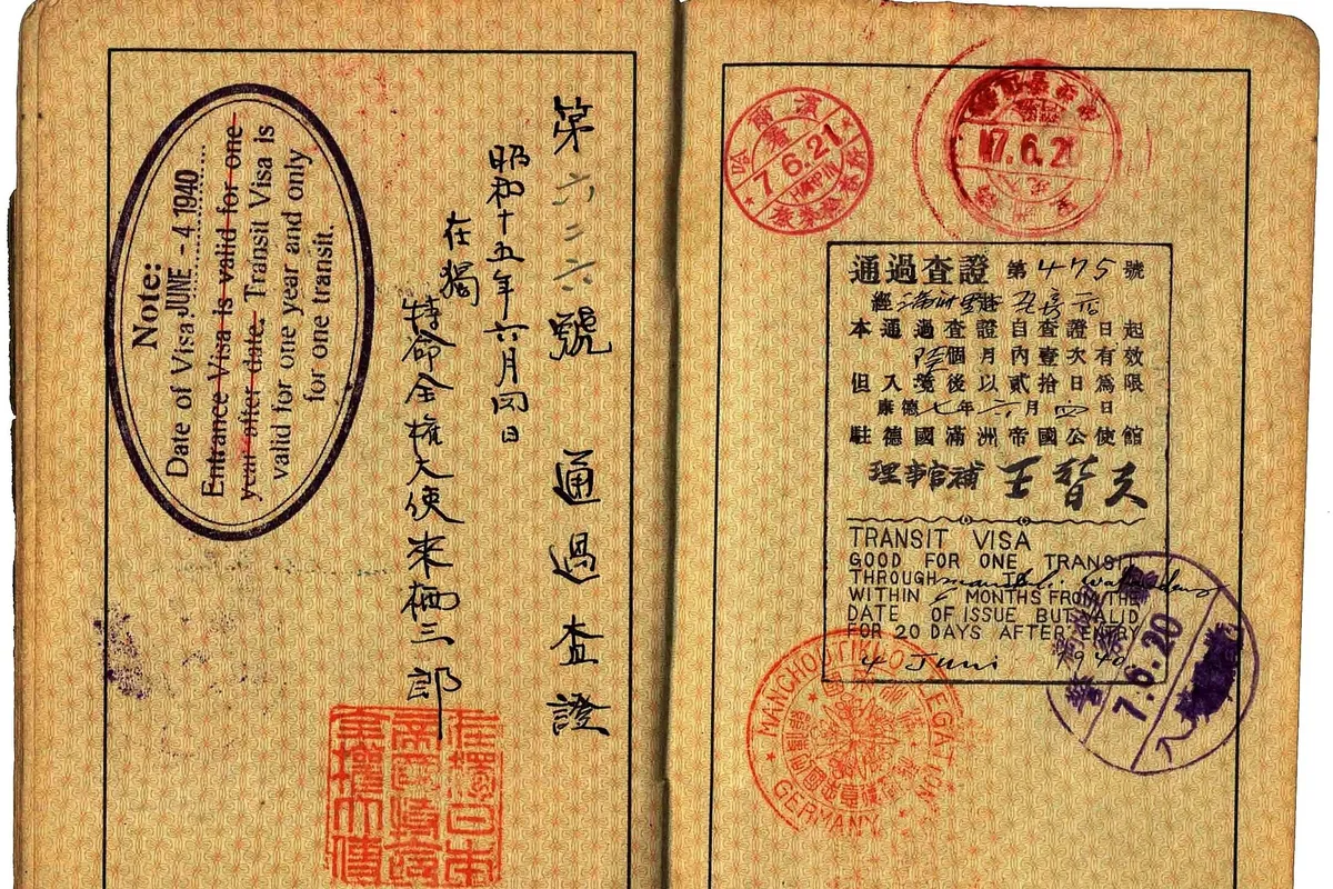 Open 1939 transit visa pages with handwritten Chinese text and red and purple official stamps, issued by diplomat Wang Tifu