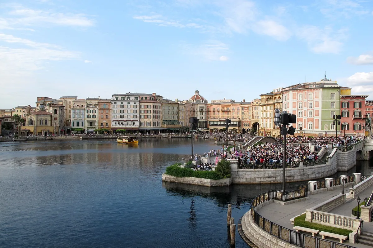 The Mediterranean Harbor at Tokyo DisneySea with Italian-style waterfront buildings and crowds gathered by the water