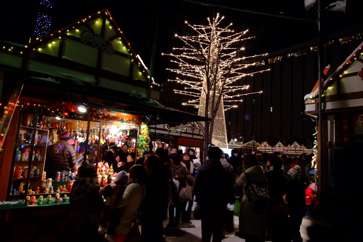 Wooden stalls decorated with Christmas lights at the Munich Christmas Market in Odori Park, Sapporo