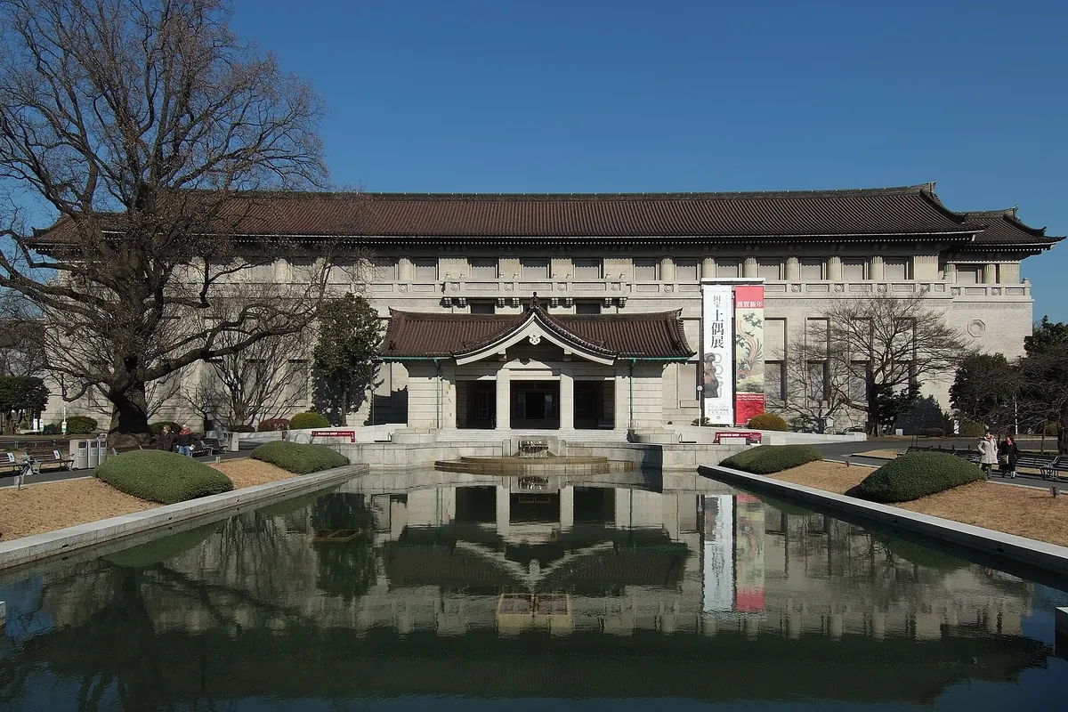 The Honkan main building of the Tokyo National Museum in Ueno Park, reflected in a pond