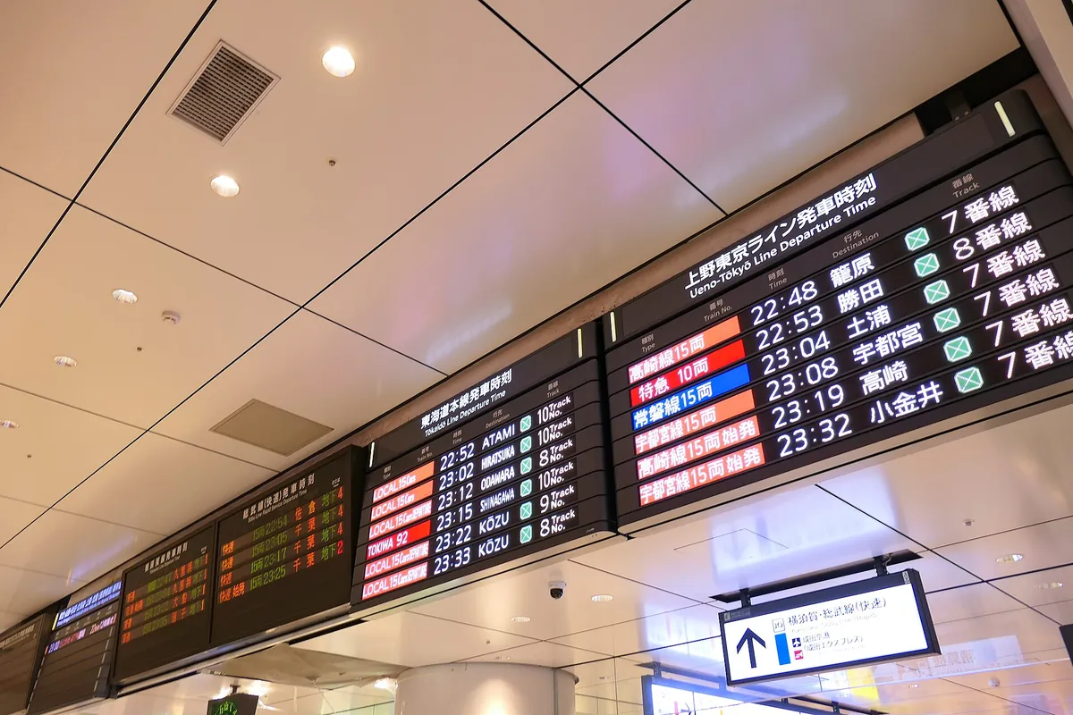 A digital departure board showing Ueno-Tokyo Line train times and destinations at a Tokyo station