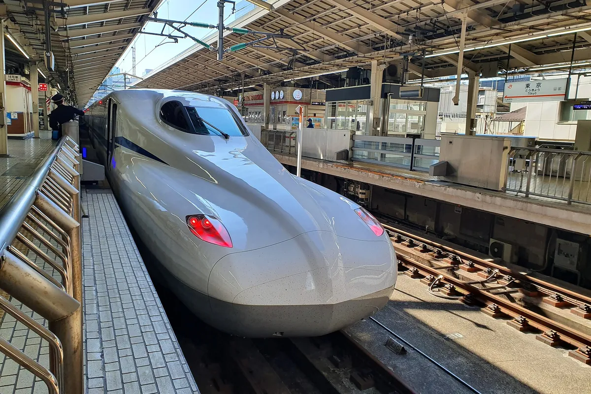 An N700S Shinkansen train stopped at a platform at Tokyo Station