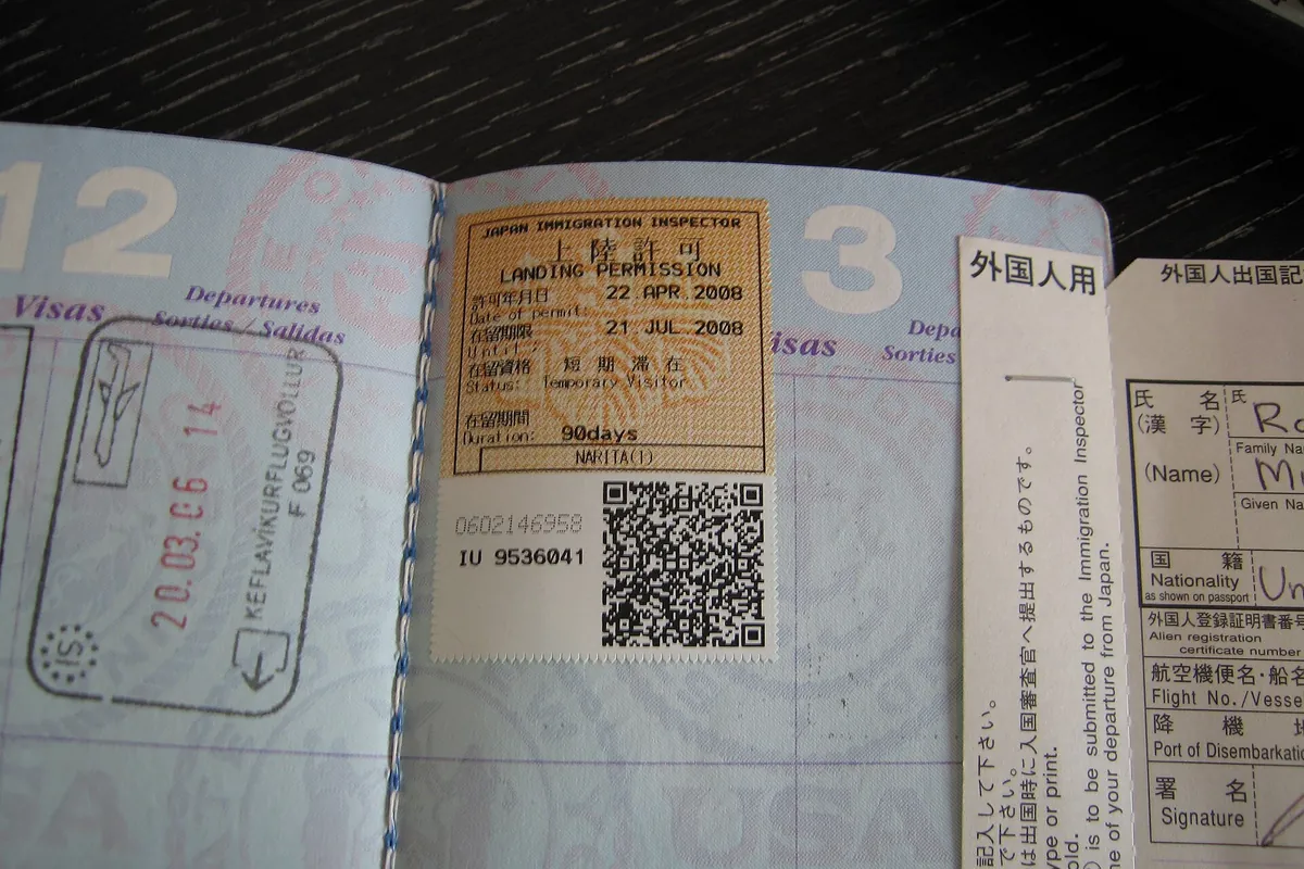 Passport page with a Japan landing permission sticker and QR code