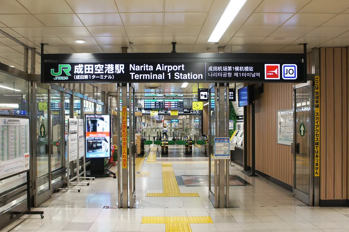 Sign and ticket gates at JR Narita Airport Terminal 1 Station entrance