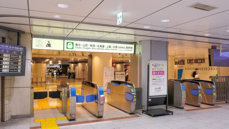Automatic ticket gates at Tokyo Station with overhead signage for the Tohoku, Yamagata, Akita, Hokkaido, Joetsu and Hokuriku