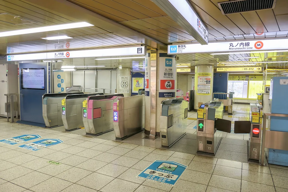 Ticket gates at Tokyo Metro Shinjuku Station with Marunouchi Line and East Gate signs overhead
