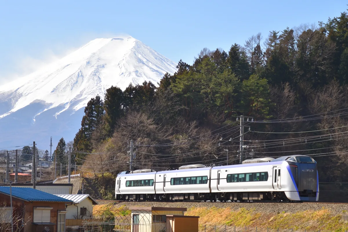 A JR East E353 series Fuji Excursion limited express train running on the Fujikyu Line with snow-covered Mount Fuji behind.