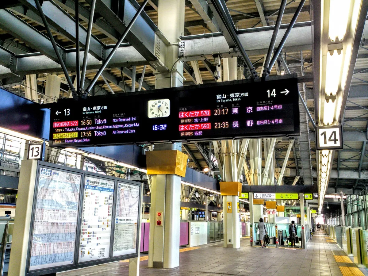 Departure boards on Shinkansen platforms 13 and 14 at Kanazawa Station listing Hakutaka and Kagayaki trains to Tokyo, in 2018