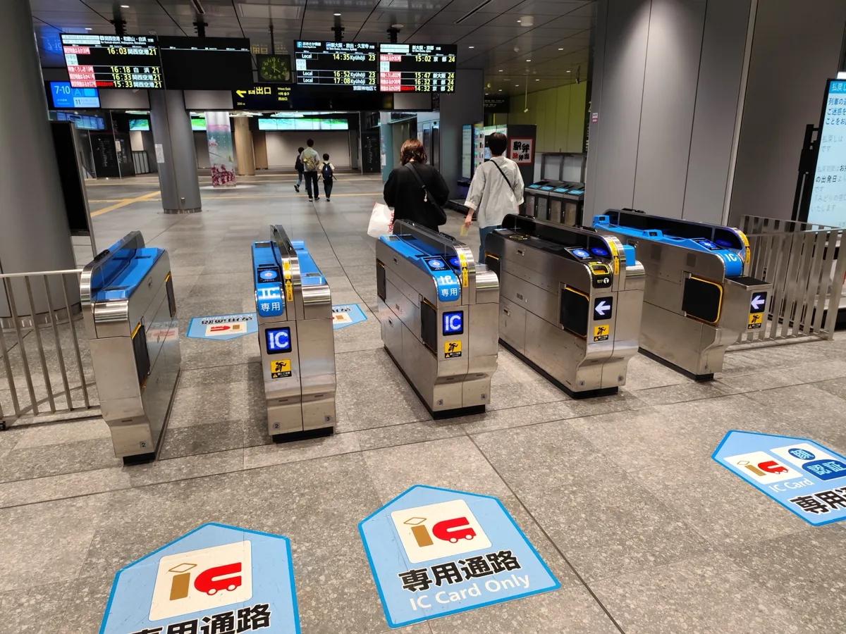 JR ticket gates with IC Card Only lanes marked on the floor at the Umekita underground gate of Osaka Station, in 2026