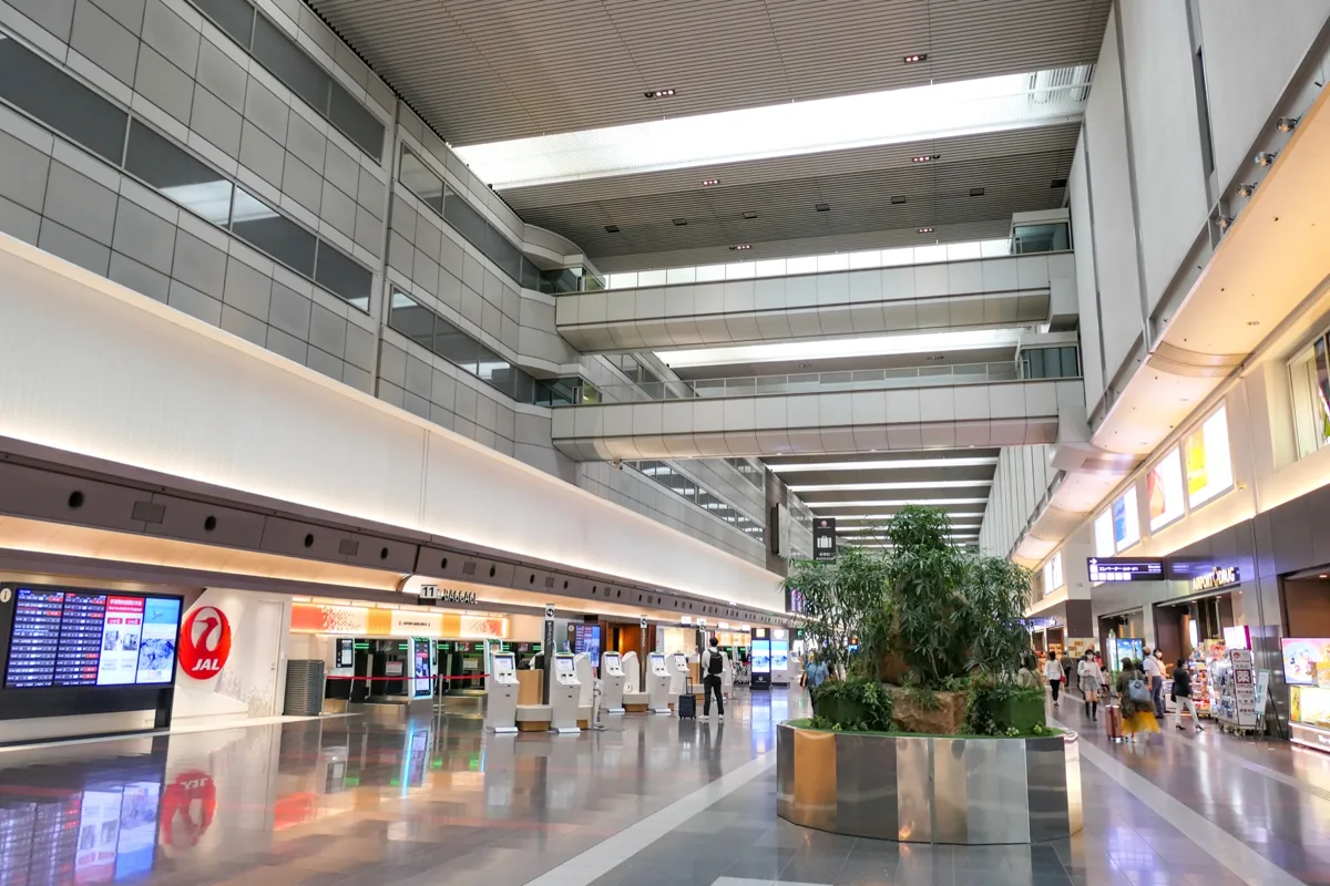 The north side of the departure lobby in Haneda Airport Terminal 1, with JAL check-in counters and a flight information.