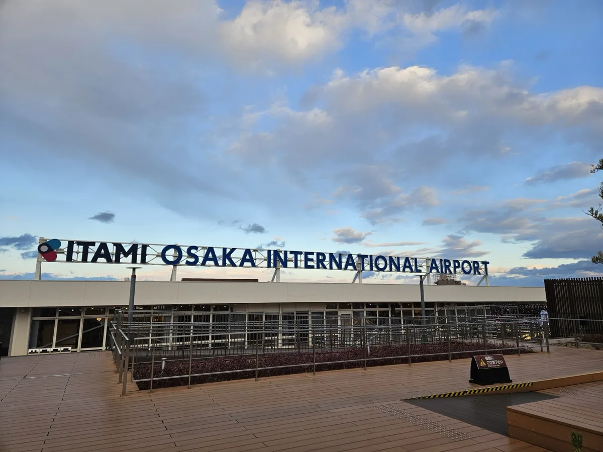 The ITAMI OSAKA INTERNATIONAL AIRPORT sign on the roof deck of the Itami Airport terminal, in 2025