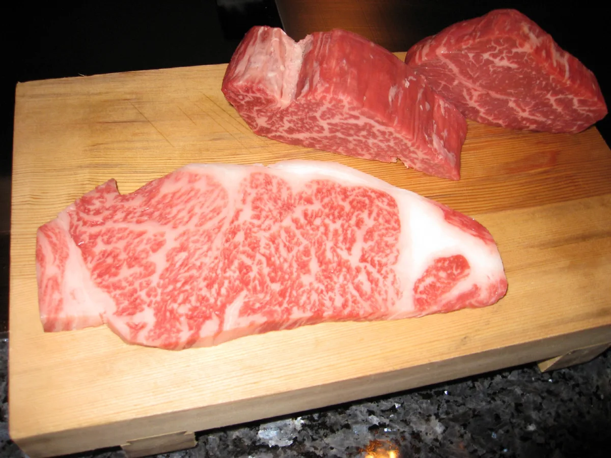 Raw marbled Kobe beef steaks on a wooden board at Mouriya, a steak restaurant in Kobe, in 2008