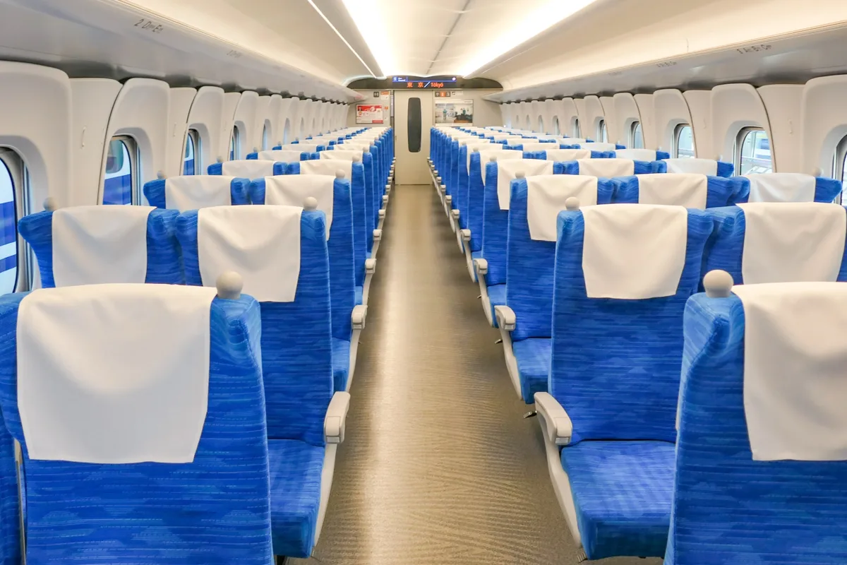 Blue ordinary-class seats in three-and-two rows inside a Tokaido Shinkansen N700S car in 2022