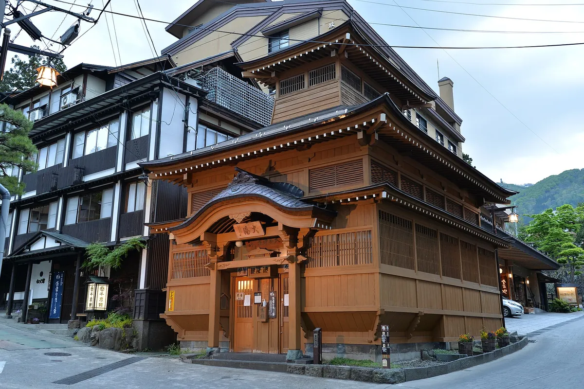 The multi-tiered wooden exterior of the Oyu public hot spring bathhouse in Nozawa Onsen